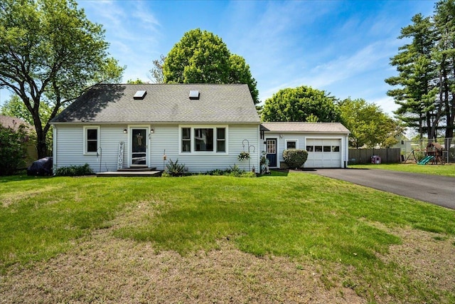 view of front facade with asphalt driveway and an attached garage