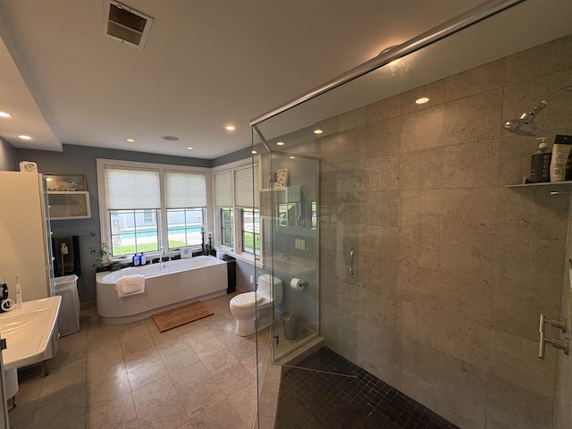28-28A Ridge Rd, Hollis, NH 03049 - bathroom with a stall shower, a freestanding bath, recessed lighting, toilet, and tile patterned flooring