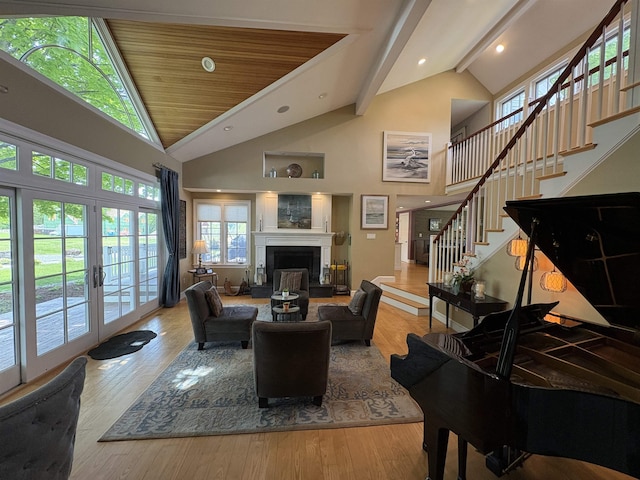 28-28A Ridge Rd, Hollis, NH 03049 - living room with stairs, high vaulted ceiling, a fireplace, wood finished floors, and beamed ceiling