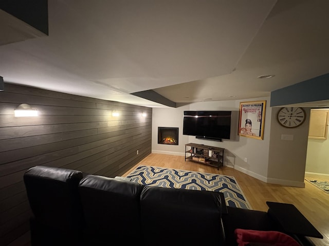 28-28A Ridge Rd, Hollis, NH 03049 - living room with wood walls, wood finished floors, baseboards, a glass covered fireplace, and an accent wall