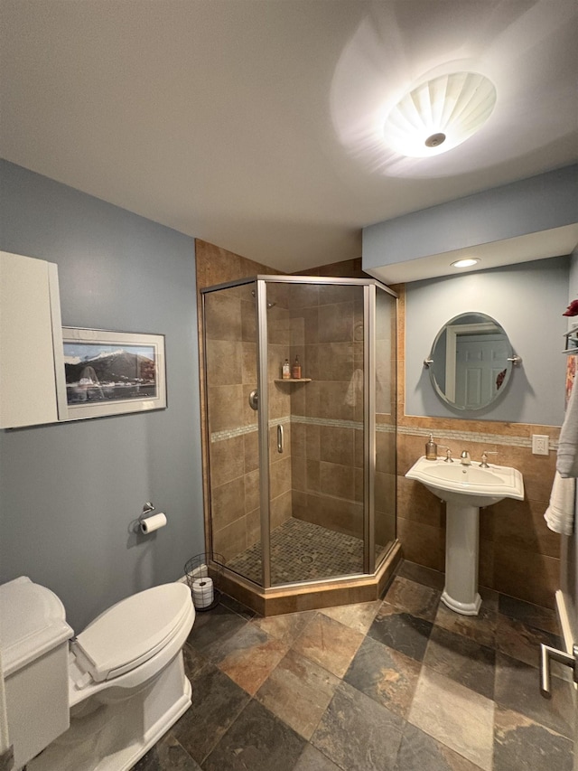 28-28A Ridge Rd, Hollis, NH 03049 - full bathroom with toilet, a stall shower, stone tile floors, tile walls, and a sink