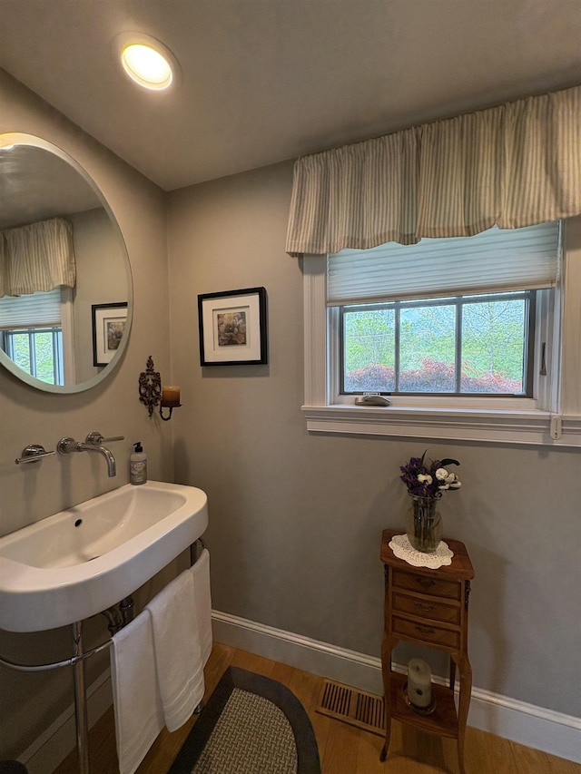 28-28A Ridge Rd, Hollis, NH 03049 - bathroom featuring wood finished floors, baseboards, and healthy amount of natural light