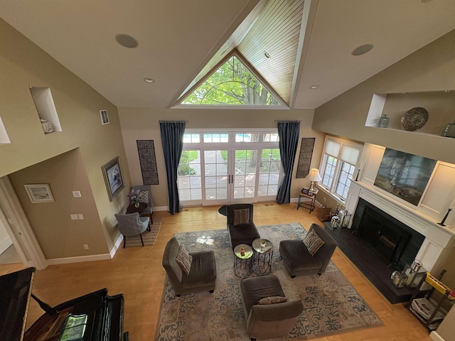 28-28A Ridge Rd, Hollis, NH 03049 - living area featuring high vaulted ceiling, a fireplace with raised hearth, light wood-style flooring, baseboards, and recessed lighting