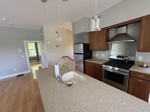 28-28A Ridge Rd, Hollis, NH 03049 - kitchen with wall chimney exhaust hood, appliances with stainless steel finishes, a sink, light wood-style floors, and light countertops