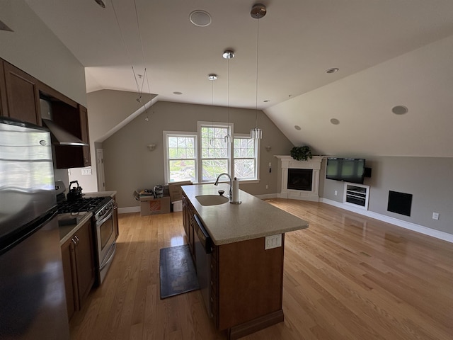 28-28A Ridge Rd, Hollis, NH 03049 - kitchen featuring appliances with stainless steel finishes, a sink, vaulted ceiling, light wood-style floors, and open floor plan