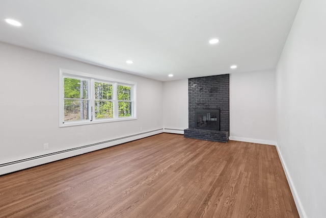 41 Elk Dr, Bedford, NH 03110 - unfurnished living room featuring wood finished floors, a fireplace, baseboard heating, baseboards, and recessed lighting