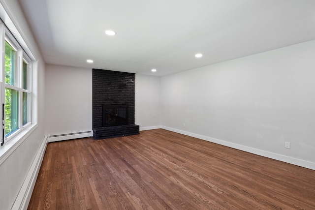 41 Elk Dr, Bedford, NH 03110 - unfurnished living room with a baseboard heating unit, wood finished floors, plenty of natural light, and recessed lighting