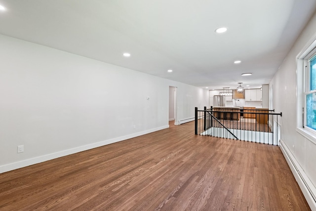 41 Elk Dr, Bedford, NH 03110 - unfurnished room with a baseboard heating unit, wood finished floors, recessed lighting, and baseboards
