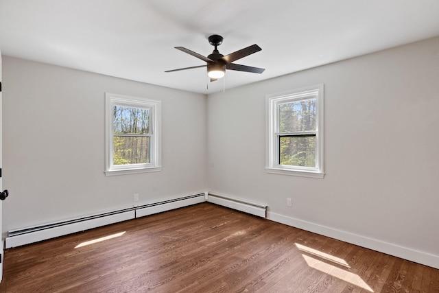 41 Elk Dr, Bedford, NH 03110 - spare room featuring baseboard heating, a ceiling fan, wood finished floors, and baseboards