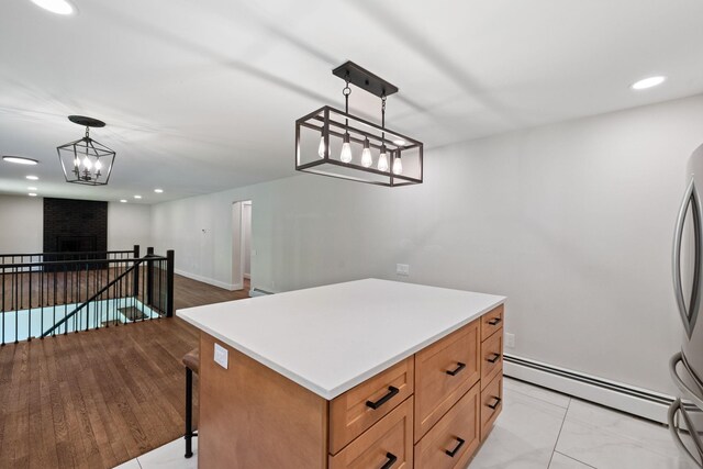 41 Elk Dr, Bedford, NH 03110 - kitchen with baseboard heating, light countertops, pendant lighting, freestanding refrigerator, and recessed lighting