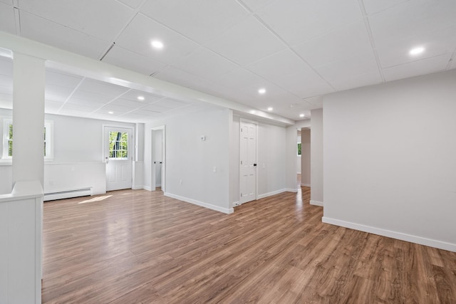 41 Elk Dr, Bedford, NH 03110 - basement with a baseboard radiator, wood finished floors, recessed lighting, and baseboards