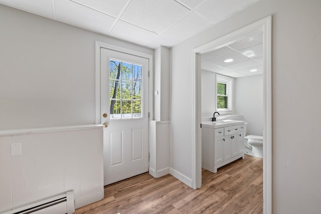 41 Elk Dr, Bedford, NH 03110 - doorway featuring baseboard heating, light wood-style flooring, plenty of natural light, a sink, and recessed lighting
