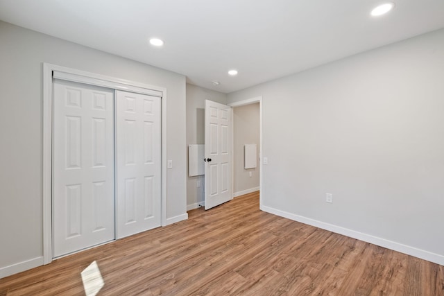 41 Elk Dr, Bedford, NH 03110 - unfurnished bedroom featuring light wood-type flooring, baseboards, recessed lighting, and a closet