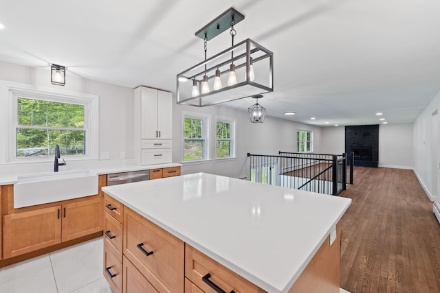 41 Elk Dr, Bedford, NH 03110 - kitchen with a sink, light countertops, recessed lighting, a center island, and a brick fireplace