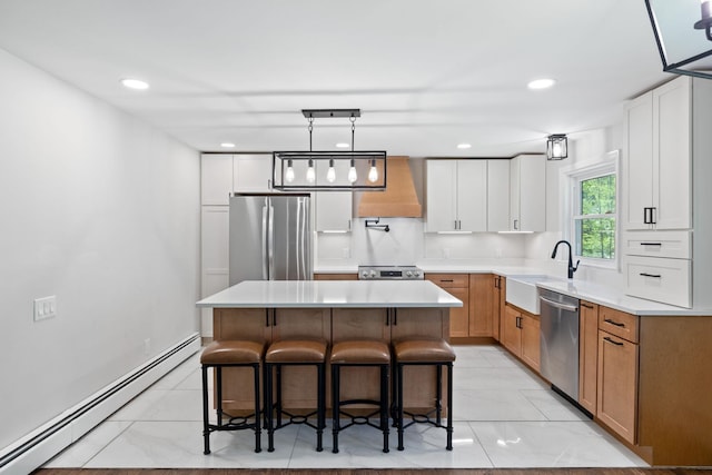 41 Elk Dr, Bedford, NH 03110 - kitchen with appliances with stainless steel finishes, a baseboard radiator, custom range hood, a sink, and a kitchen bar