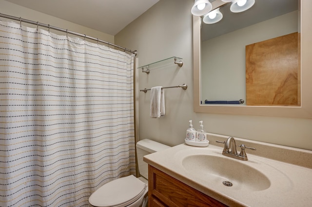 bathroom featuring toilet, vanity, and curtained shower