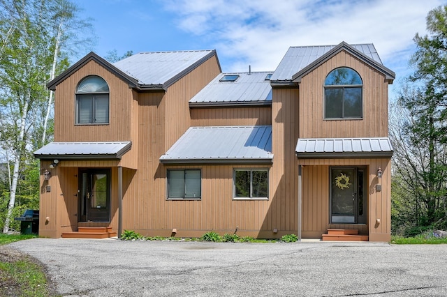 view of front of home with entry steps and metal roof