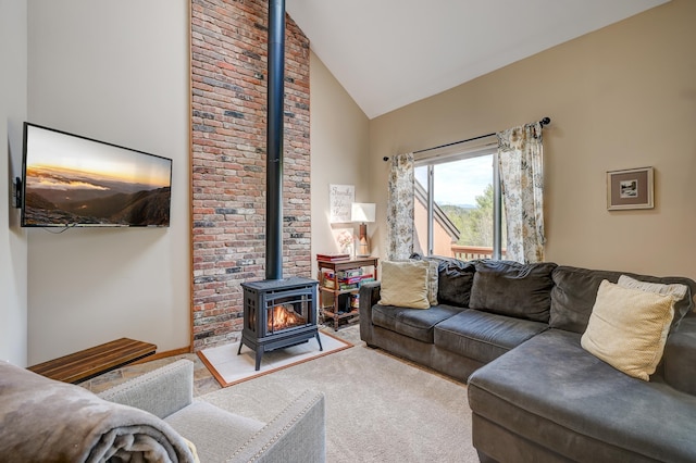 living area with a wood stove, high vaulted ceiling, and carpet