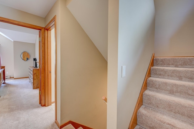 stairway featuring carpet floors, baseboards, and a baseboard heating unit