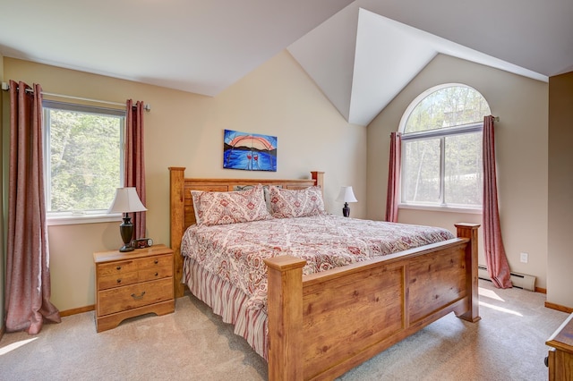 bedroom featuring a baseboard heating unit, multiple windows, light colored carpet, vaulted ceiling, and baseboards