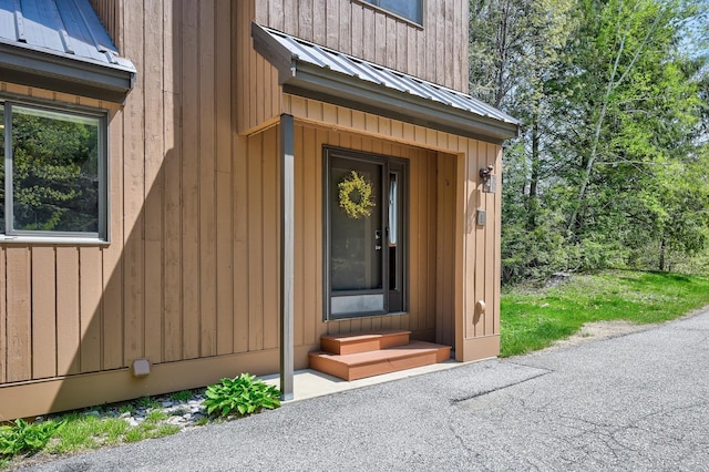 view of exterior entry with metal roof