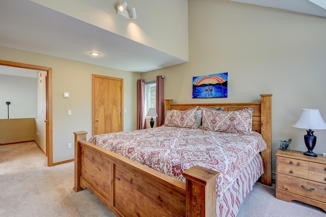 bedroom with light colored carpet, baseboards, and a closet