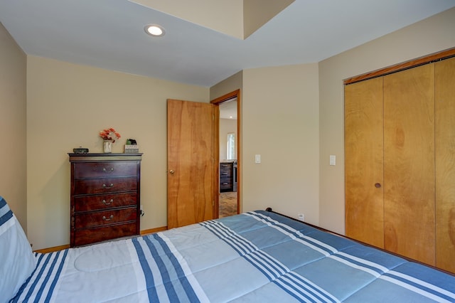 bedroom with recessed lighting and a closet
