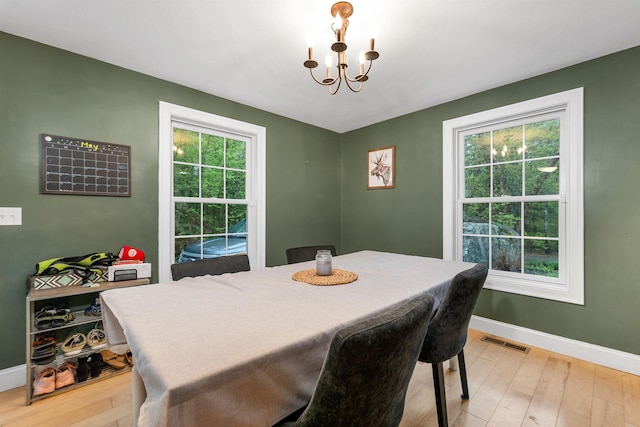 268 Lesmerises Rd, Loudon, NH 03307 - dining area with a chandelier, baseboards, and light wood finished floors