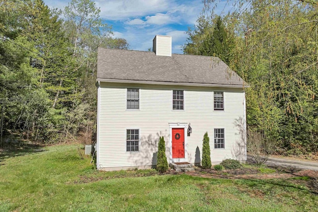 268 Lesmerises Rd, Loudon, NH 03307 - colonial-style house with entry steps, a front yard, a chimney, cooling unit, and a shingled roof