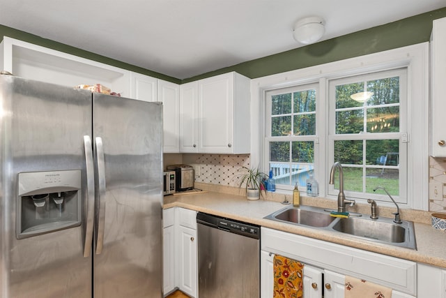 268 Lesmerises Rd, Loudon, NH 03307 - kitchen with stainless steel appliances, a sink, white cabinetry, light countertops, and decorative backsplash