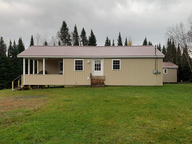 manufactured / mobile home featuring a front yard, metal roof, and entry steps