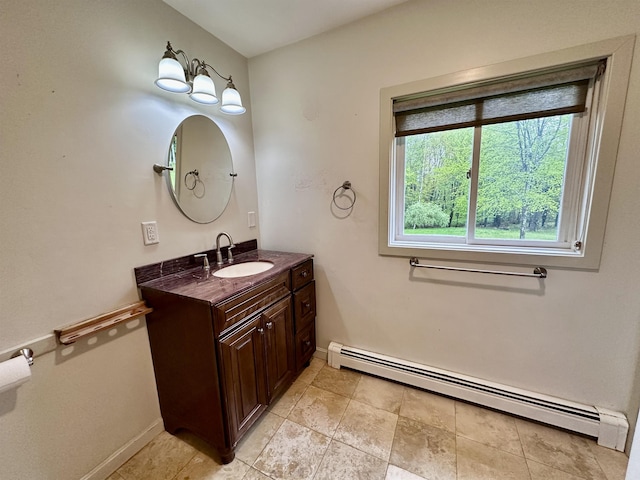 bathroom with a baseboard heating unit, baseboards, vanity, and tile patterned flooring