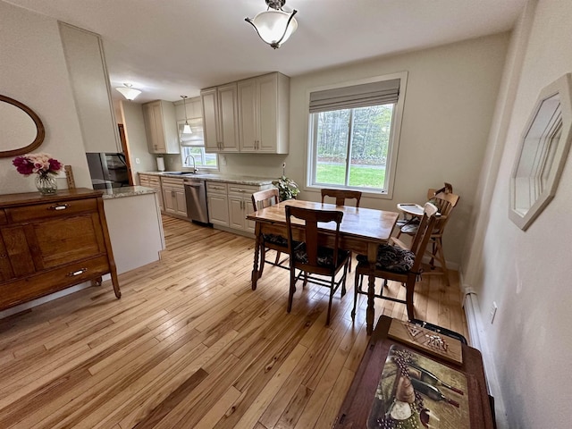 dining space featuring light wood-style flooring