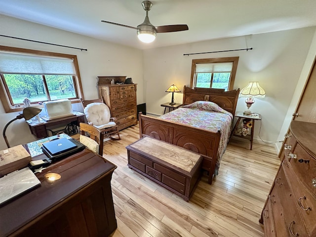 bedroom with light wood-type flooring and a ceiling fan