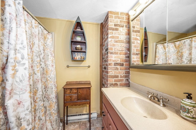 bathroom featuring baseboard heating, vanity, and a textured ceiling