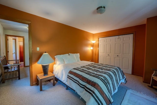 bedroom with carpet flooring, a closet, and baseboards