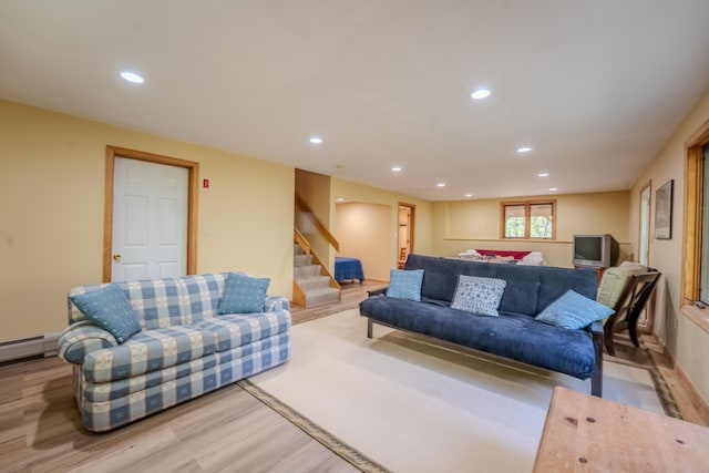 living room with wood finished floors, stairs, recessed lighting, and a baseboard heating unit