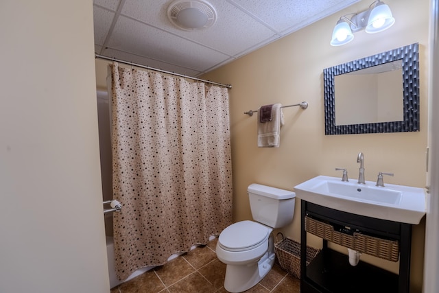 full bath with toilet, tile patterned flooring, a paneled ceiling, and vanity