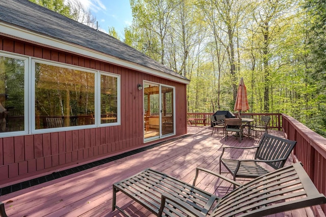 wooden terrace with outdoor dining area