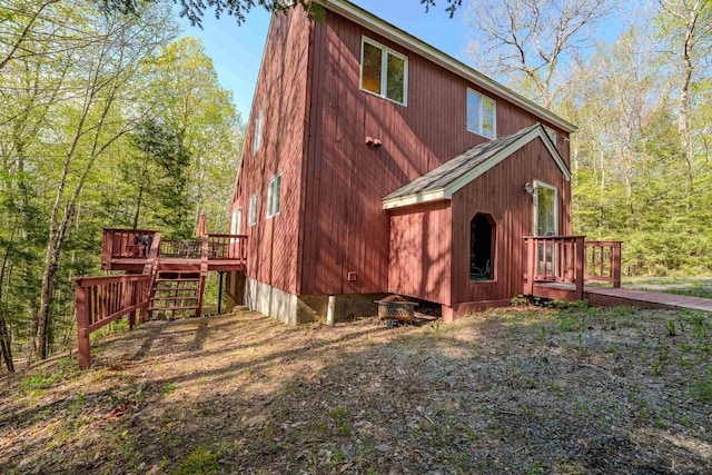 view of home's exterior featuring a wooden deck