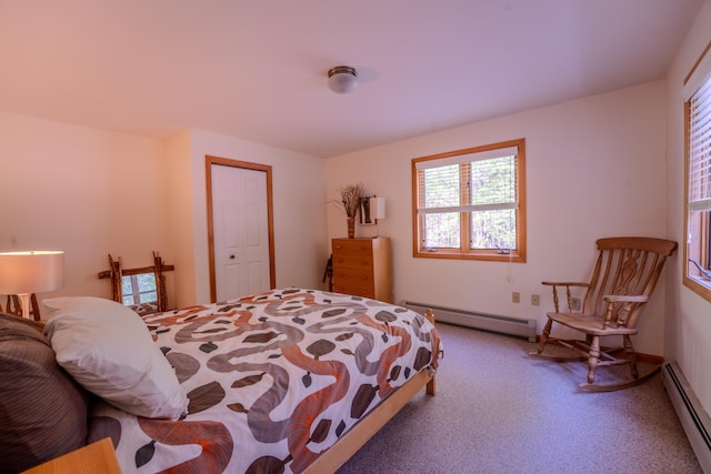 carpeted bedroom featuring a baseboard heating unit