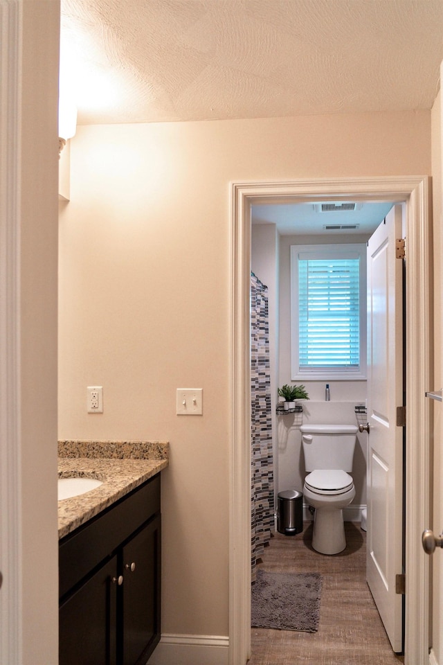 29 Bennett St, Nashua, NH 03064 - full bath with vanity, toilet, curtained shower, and baseboards