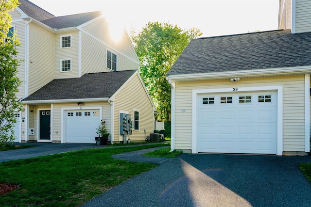 29 Bennett St, Nashua, NH 03064 - view of side of home featuring driveway, a garage, a shingled roof, and a yard