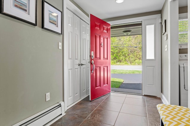 1385 Front St, Manchester, NH 03102 - foyer entrance featuring a baseboard radiator, washer / clothes dryer, dark tile patterned floors, and baseboards