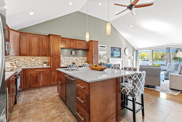 1385 Front St, Manchester, NH 03102 - kitchen with a sink, open floor plan, high vaulted ceiling, a breakfast bar, and stainless steel appliances