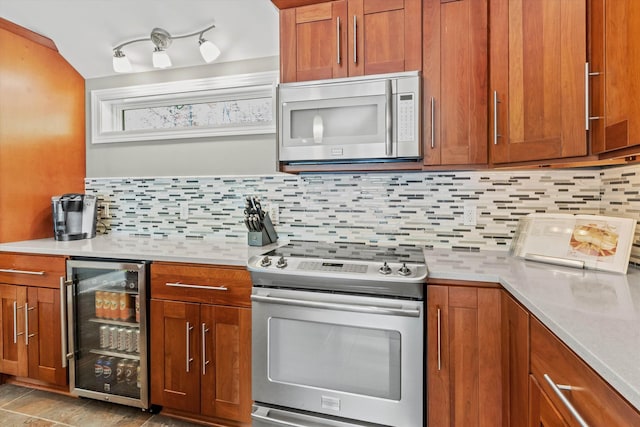 1385 Front St, Manchester, NH 03102 - kitchen with stainless steel appliances, wine cooler, brown cabinets, light countertops, and decorative backsplash