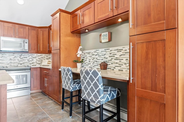 1385 Front St, Manchester, NH 03102 - kitchen with appliances with stainless steel finishes, backsplash, and light countertops
