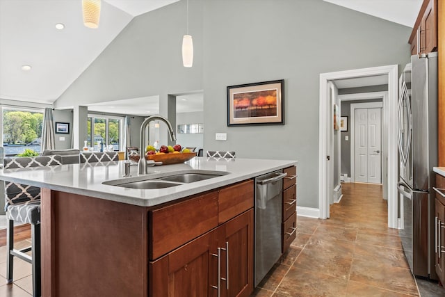 1385 Front St, Manchester, NH 03102 - kitchen featuring stainless steel appliances, a sink, high vaulted ceiling, a center island with sink, and light countertops