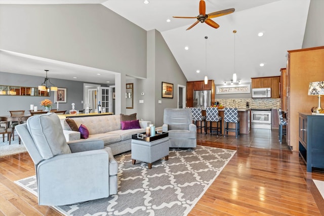 1385 Front St, Manchester, NH 03102 - living room featuring high vaulted ceiling, light wood-style floors, ceiling fan, a chandelier, and recessed lighting