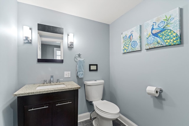 1385 Front St, Manchester, NH 03102 - half bathroom featuring baseboards, toilet, vanity, and tile patterned floors